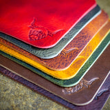 handcrafted full grain and vegetable tanned leather coasters with highland cow illustration